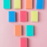 Top view of colorful washing sponges, on pink