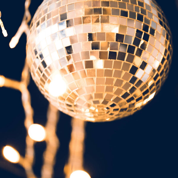 close-up shot of glossy disco ball with garland