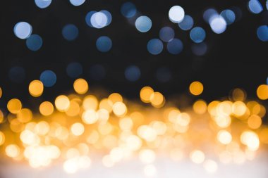 christmas golden bokeh lights on dark background clipart
