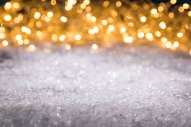 christmas winter background with snow and shiny blurred lights clipart