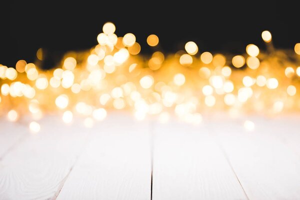 festive bokeh lights on white wooden surface, christmas background