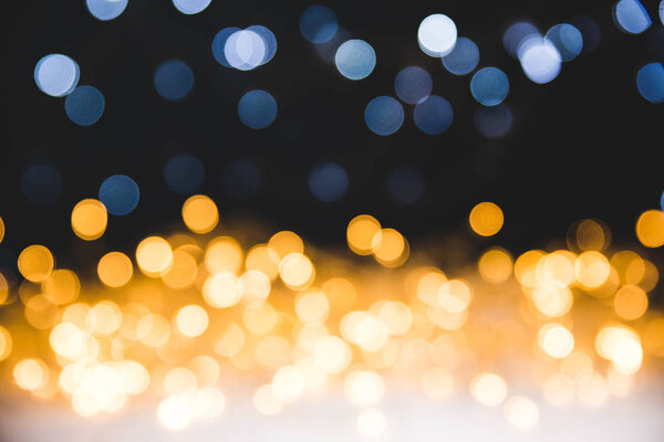 christmas golden bokeh lights on dark background