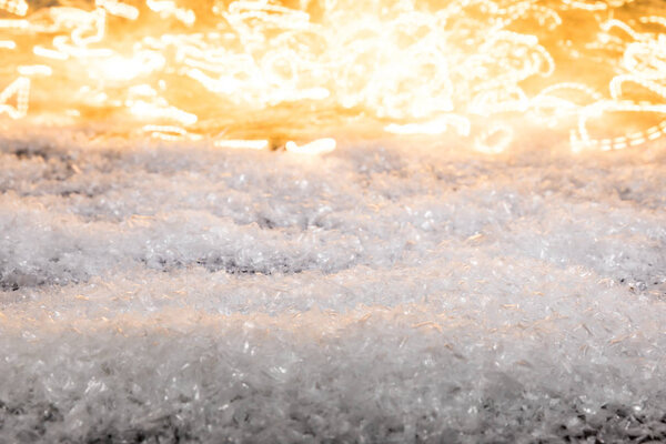 christmas winter background with snow and shiny blurred lights 