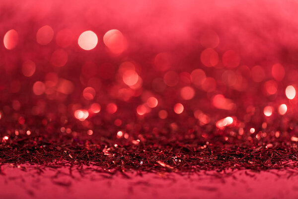 christmas background with red shiny blurred confetti 
