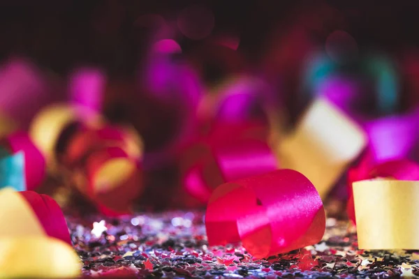 colorful christmas confetti and shiny stars with blurred background
