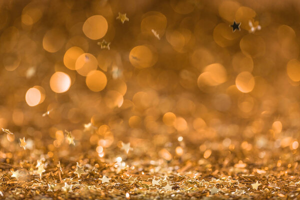 christmas background with falling golden shiny confetti stars 