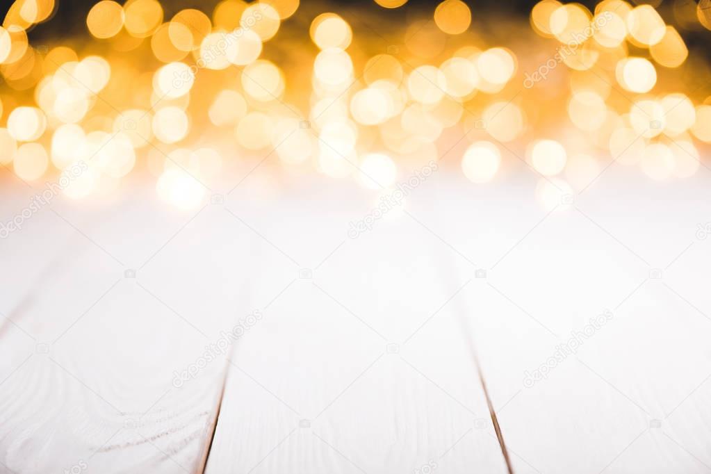 magical blurred lights on white wooden surface, christmas texture