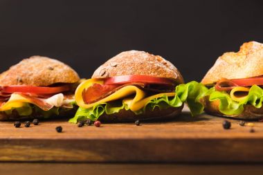 close up of sandwiches with cheese and vegetables clipart