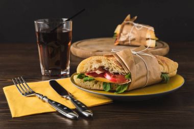 cooked panini on yellow plate and knife with fork clipart