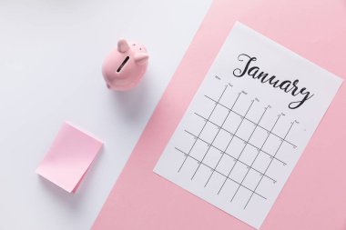 top view of arranged calendar, piggy bank and empty sticky notes clipart