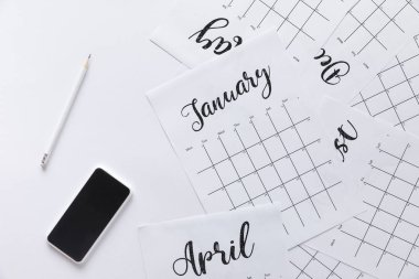 flat lay with calendar, smartphone and pencil isolated on white clipart