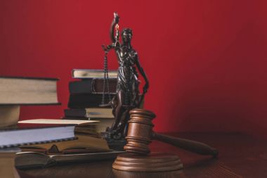 opened juridical books with lady justice statue and gavel on wooden table, law concept clipart