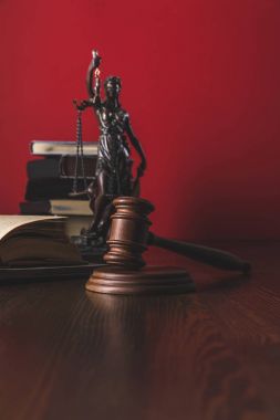opened juridical books with lady justice statue and gavel on wooden table, law concept clipart