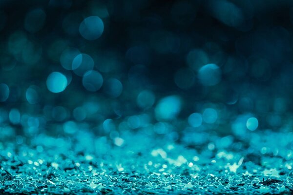 Праздничный фон с блестящими конфетти в бирюзовых тонах
 