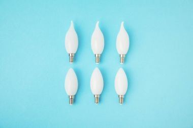 top view of different white lamps isolated on blue clipart