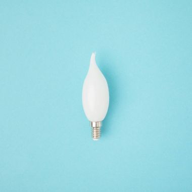 close up view of white light bulb isolated on blue clipart