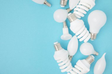 top view of different white lamps isolated on blue clipart