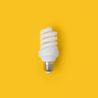 close up view of white light bulb isolated on yellow clipart