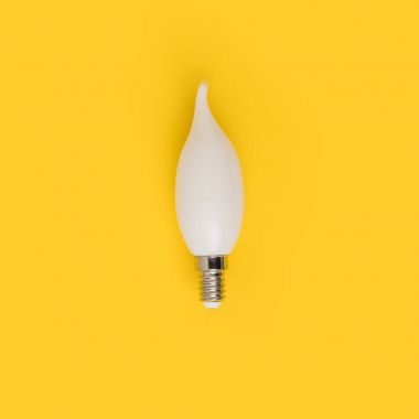 close up view of white light bulb isolated on yellow clipart