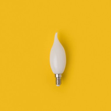 close up view of white light bulb isolated on yellow clipart