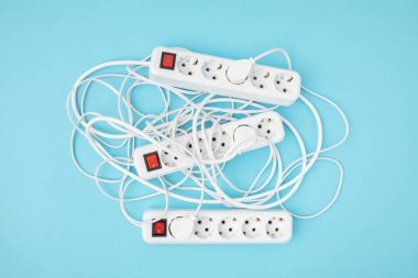 top view of arrangement of extension cords isolated on blue clipart