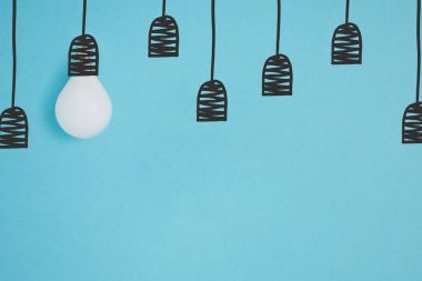 flat lay with white light bulb pretending hanging on string isolated on blue clipart