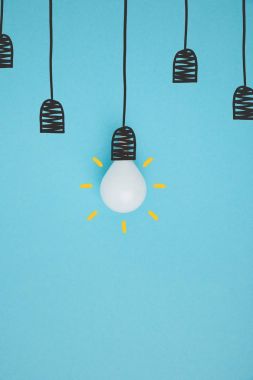 top view of light bulb pretending hanging on lamp holder isolated on blue