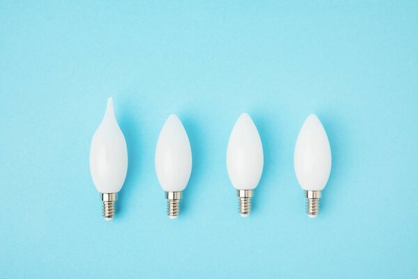 top view of different white lamps isolated on blue