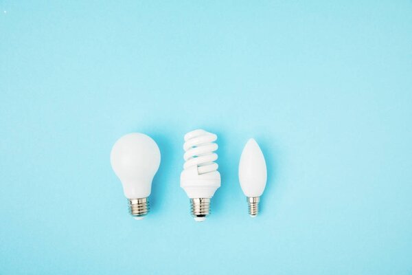 top view of different white lamps isolated on blue