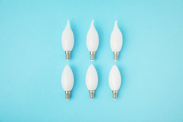 top view of different white lamps isolated on blue