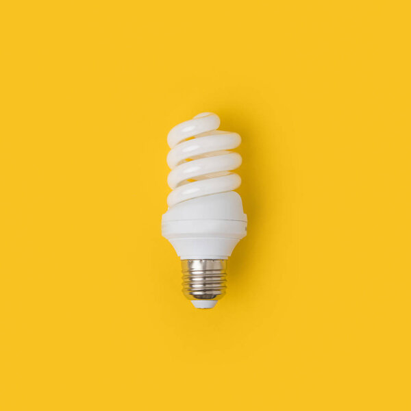 close up view of white light bulb isolated on yellow