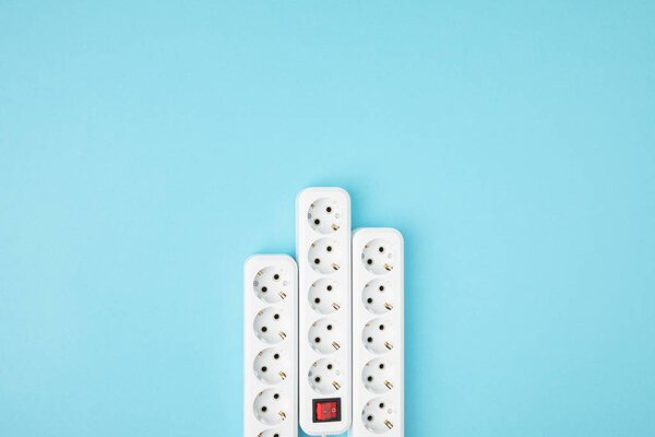 top view of arrangement of extension cords isolated on blue