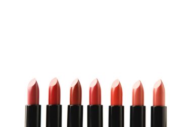 row of lipsticks of various shades isolated on white clipart
