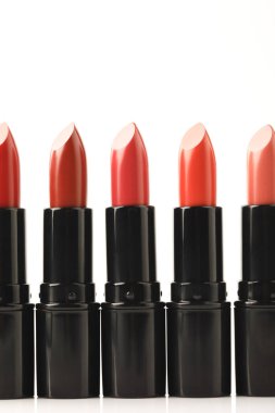 row of lipsticks of different shades isolated on white clipart