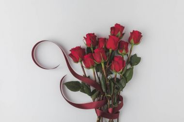 top view of beautiful red roses with ribbon isolated on white, st valentines day concept clipart