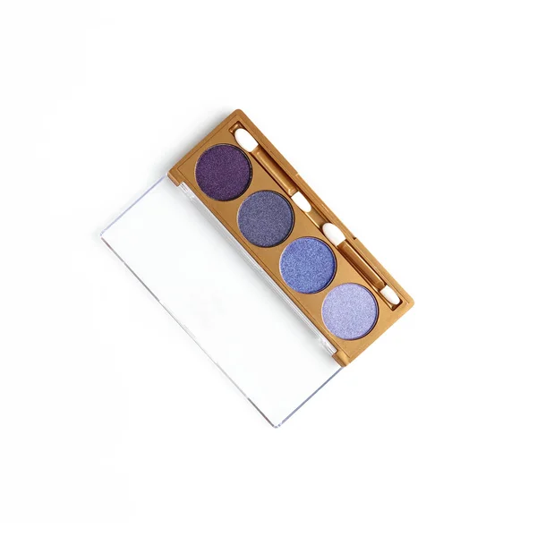 top view of opened container with different shaded purple cosmetic eye shadows isolated on white