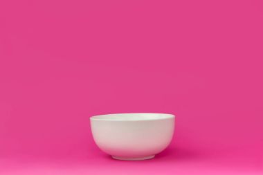 close-up view of single empty white bowl ready for breakfast isolated on pink  clipart