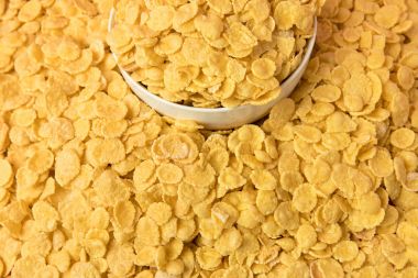 close-up view of tasty crispy corn flakes and white bowl   clipart