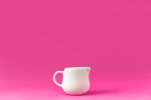 крупным планом один пустой белый кувшин готов к завтраку изолирован на розовый
 