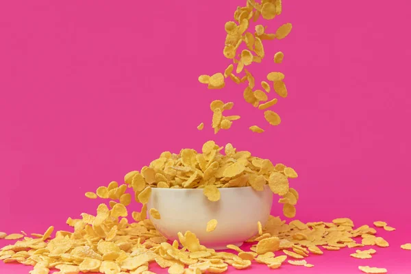 Close View Sweet Delicious Corn Flakes Falling White Bowl Pink — Stock Photo, Image