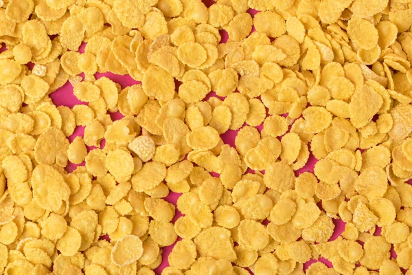 Blick Von Oben Auf Köstliche Knusprige Cornflakes Auf Rosa — kostenloses Stockfoto