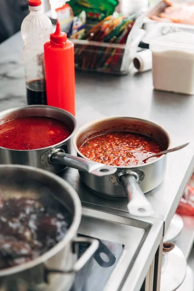 Close-up shot of sauces in pans at restaurant kitchen — Stock Image Close Shot Sauces Pans Restaurant Kitchen Stock Picture