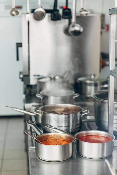 Various soup cooking in sauce pans at restaurant kitchen — Stock Image Various Soup Cooking Sauce Pans Restaurant Kitchen Stock Photo