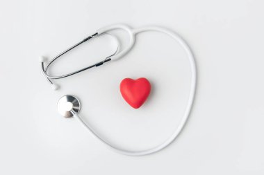 stethoscope with red heart laying isolated on white background     clipart