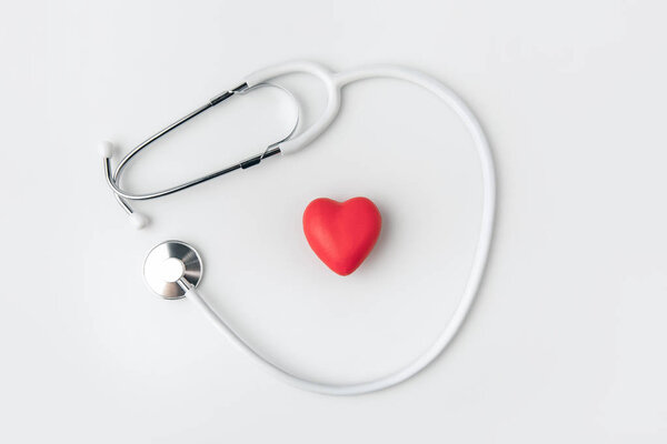 stethoscope with red heart laying isolated on white background    