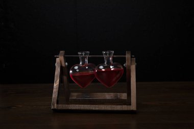 two heart shaped glass jars with rose perfume clipart