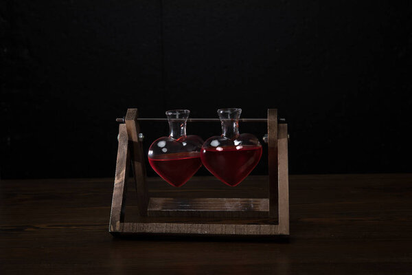 two heart shaped glass jars with rose perfume