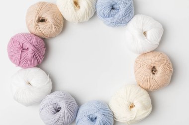 top view of circle of colored yarn balls on white background   clipart