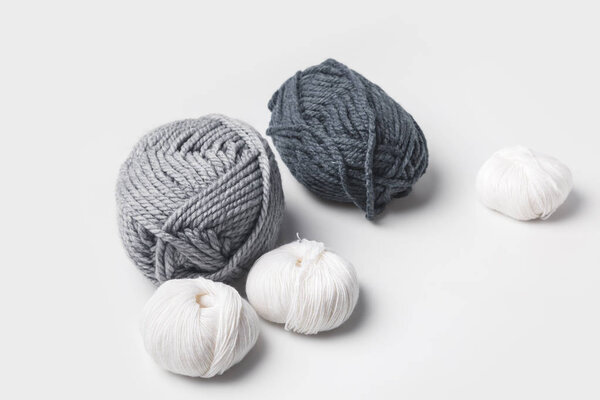 grey and white yarn balls isolated on white 