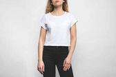 cropped shot of young woman in blank t-shirt on white